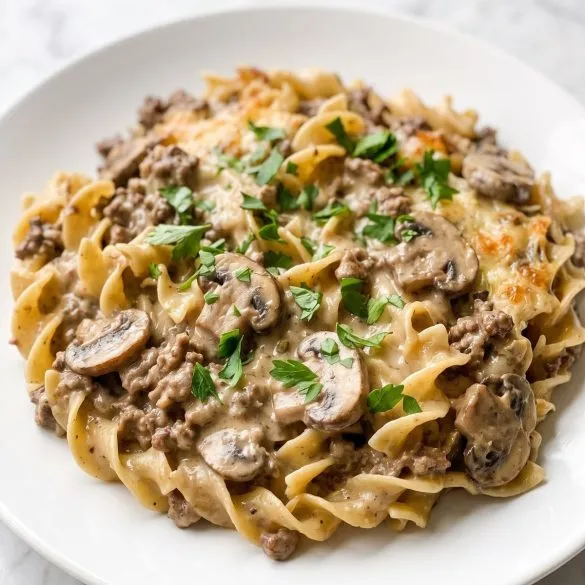 A serving of creamy beef stroganoff casserole with egg noodles, ground beef and mushrooms on a plate