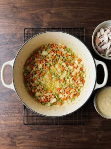 Step 1: Soft diced onion, carrots, celery, and garlic in melted butter in a Dutch oven.