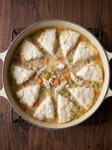 Step 4: Flour-coated biscuit quarters in a single layer on top of the creamy chicken broth.