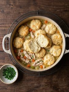 Step 6: A cooked biscuit dumpling cut in half to show its fluffy, bread-like center.