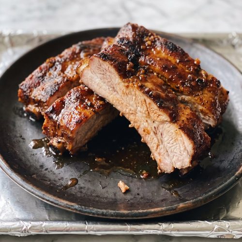 Barbecue-glazed country-style pork ribs cut open to show the tender meat