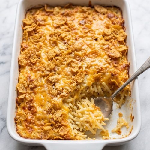 A baking dish of funeral potatoes with a golden cornflake crust