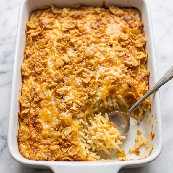 A baking dish of funeral potatoes with a golden cornflake crust