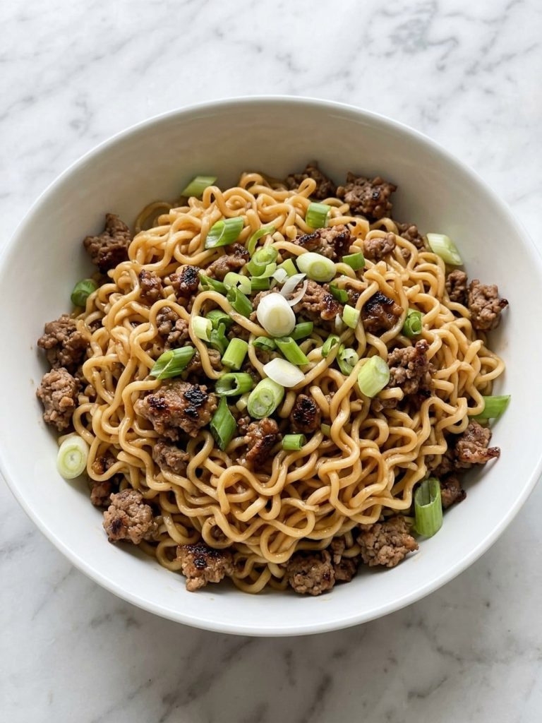 A bowl of hamburger ramen with ground beef and green onion