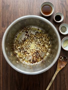 Step 3: softened chopped onion and minced garlic in the Instant Pot insert, with browned bits from the beef on the bottom.