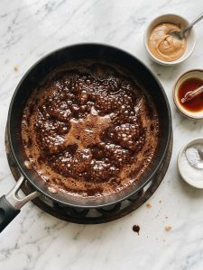 Step 3: Chocolate syrup in a saucepan has large bubbles across its whole surface at the end of the one-minute boil.