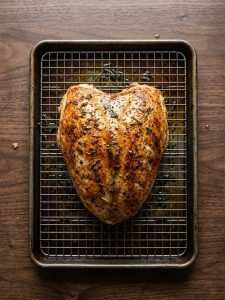 Step 5: Whole cooked turkey breast has golden skin after a brief broil.