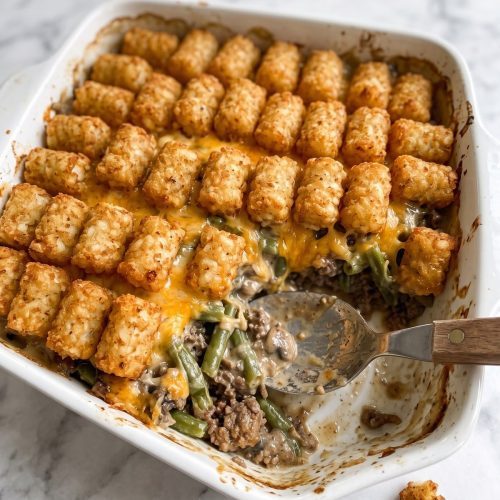 A baking dish of tater tot casserole with a crispy golden tater tot top