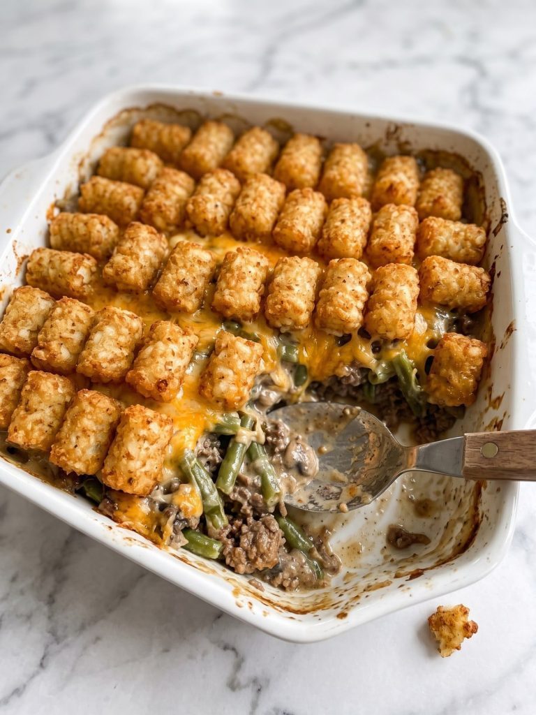 A baking dish of tater tot casserole with a crispy golden tater tot top