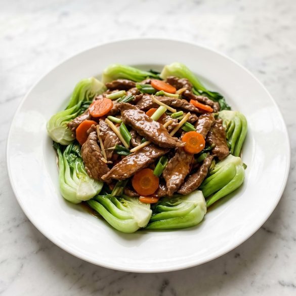 Beef and bok choy stir fry with glossy sauce on a white plate