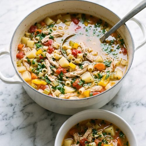 A pot of Sicilian chicken soup with shredded chicken, potatoes, vegetables, tomatoes and ditalini