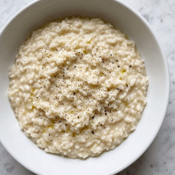 A bowl of creamy white rice with Parmesan and black pepper
