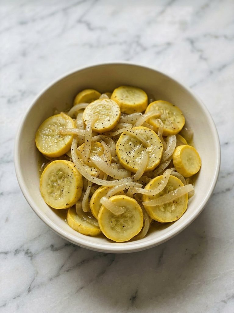 A full bowl of buttery stewed yellow squash and onions